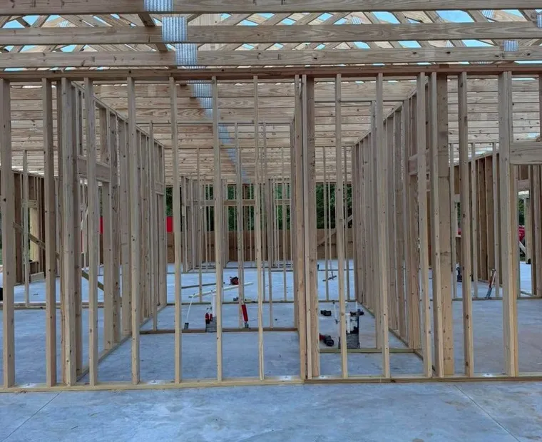 Custom home under construction with its metal roof going on