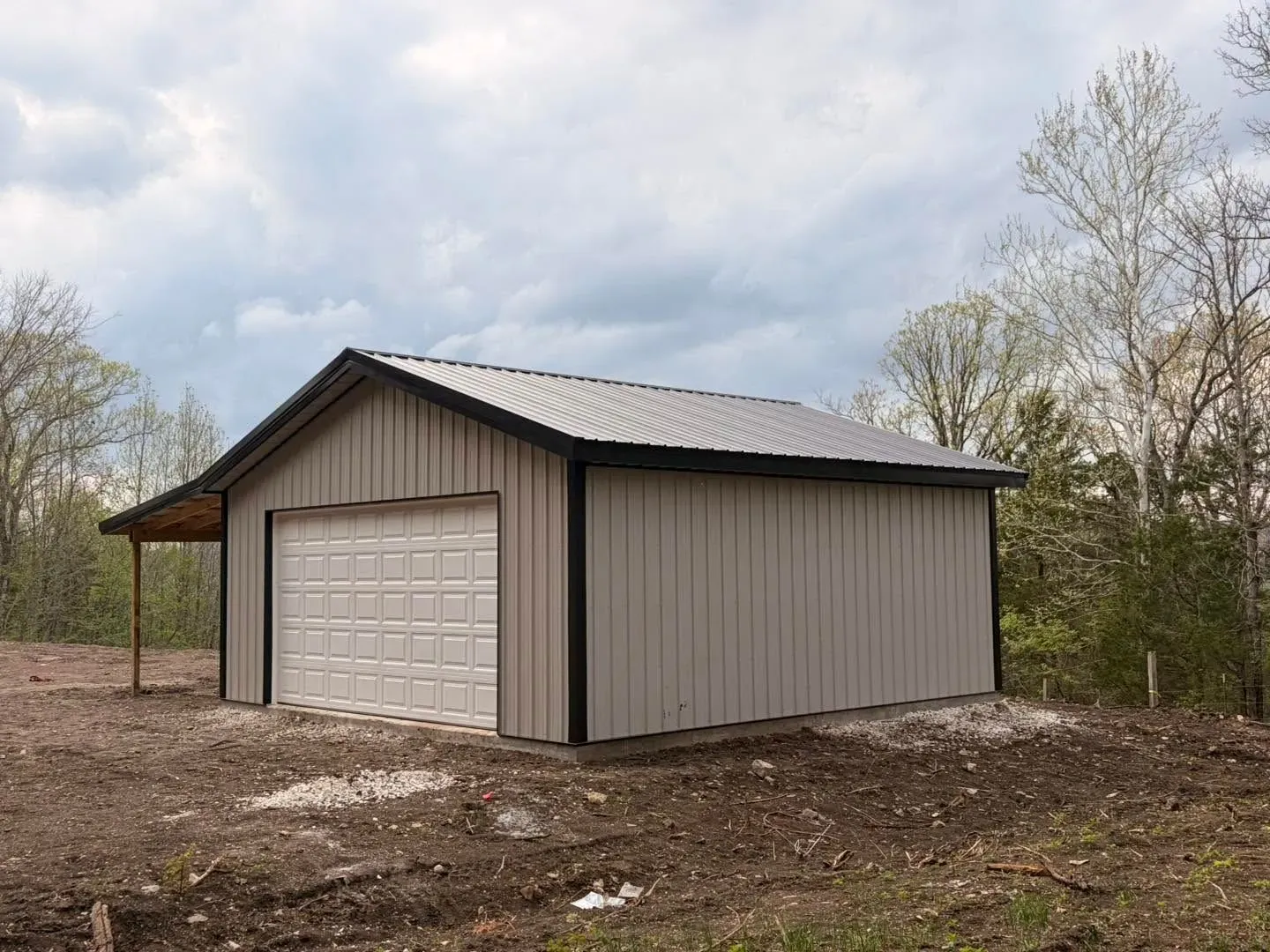 Sundown Roofing & Construction A completed pole barn with a roller door