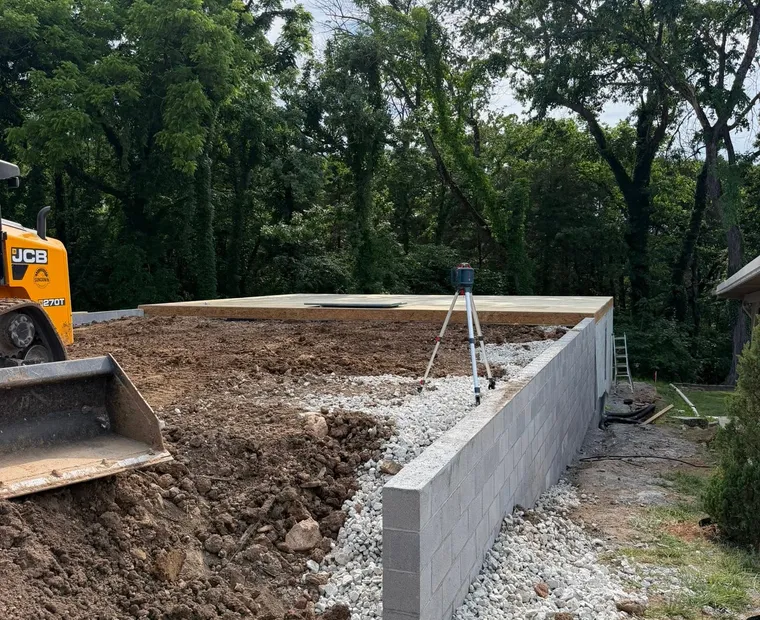 Foundations A concrete block stem wall with drainage stone along its base, set out with a laser level on a sloping site