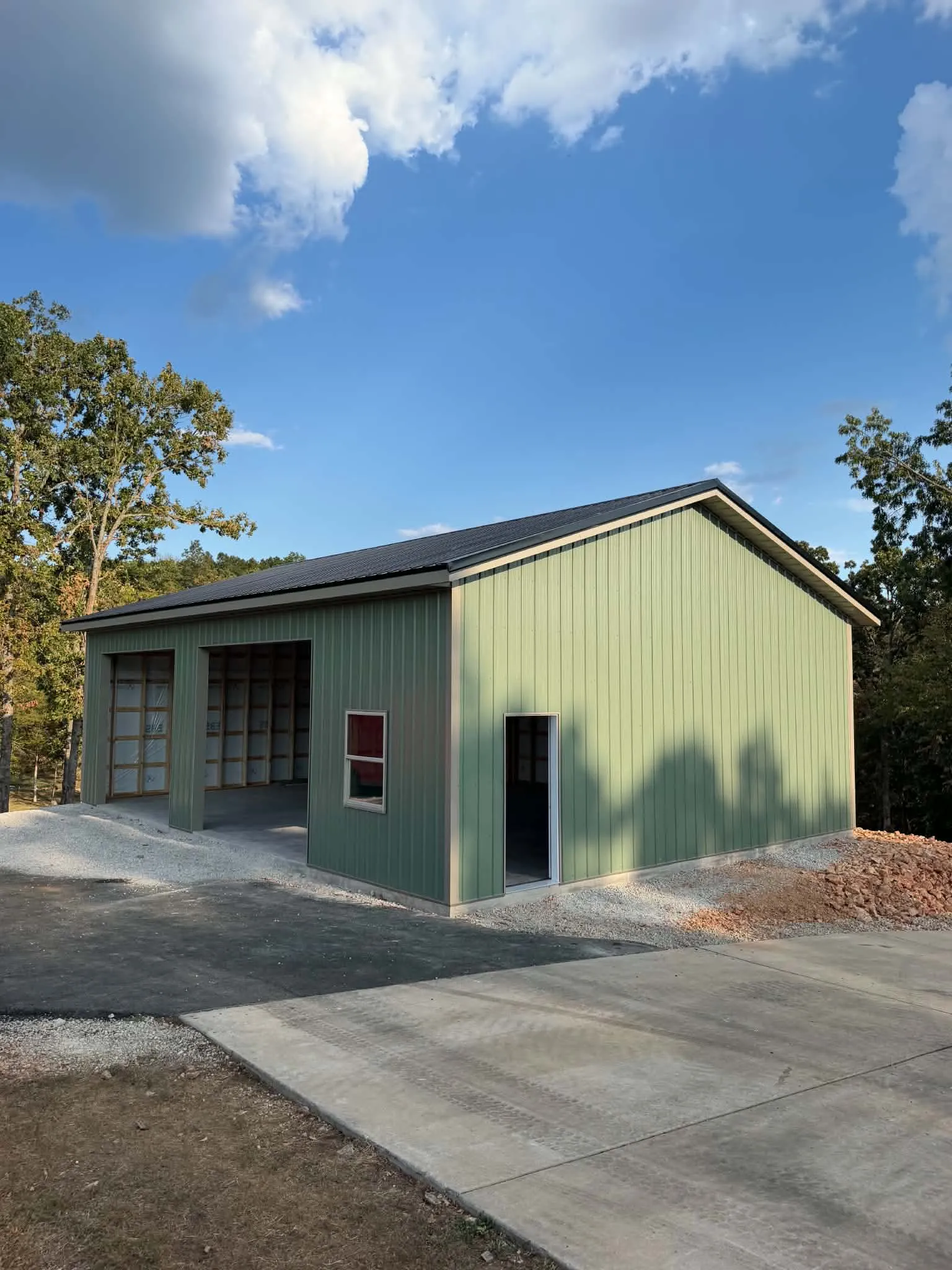 Sundown Roofing & Construction A completed pole barn with a roller door