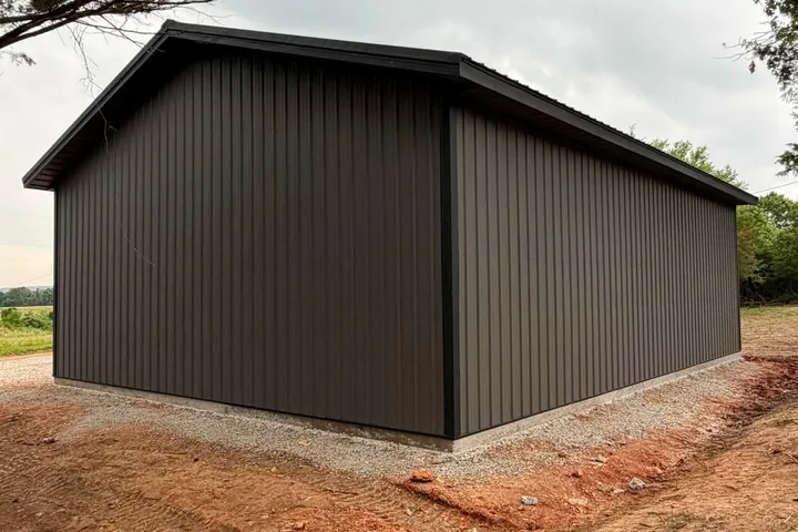 Charcoal metal building, Shell Knob MO A second building finished in plain charcoal metal siding and roof, sitting on a concrete stem wall with fresh gravel around it