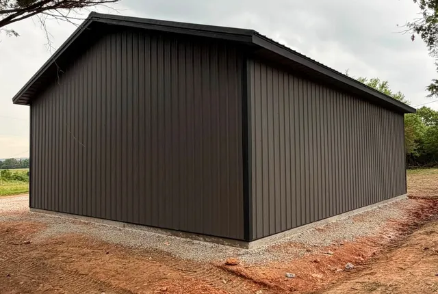 Charcoal metal building, Shell Knob MO A second building finished in plain charcoal metal siding and roof, sitting on a concrete stem wall with fresh gravel around it